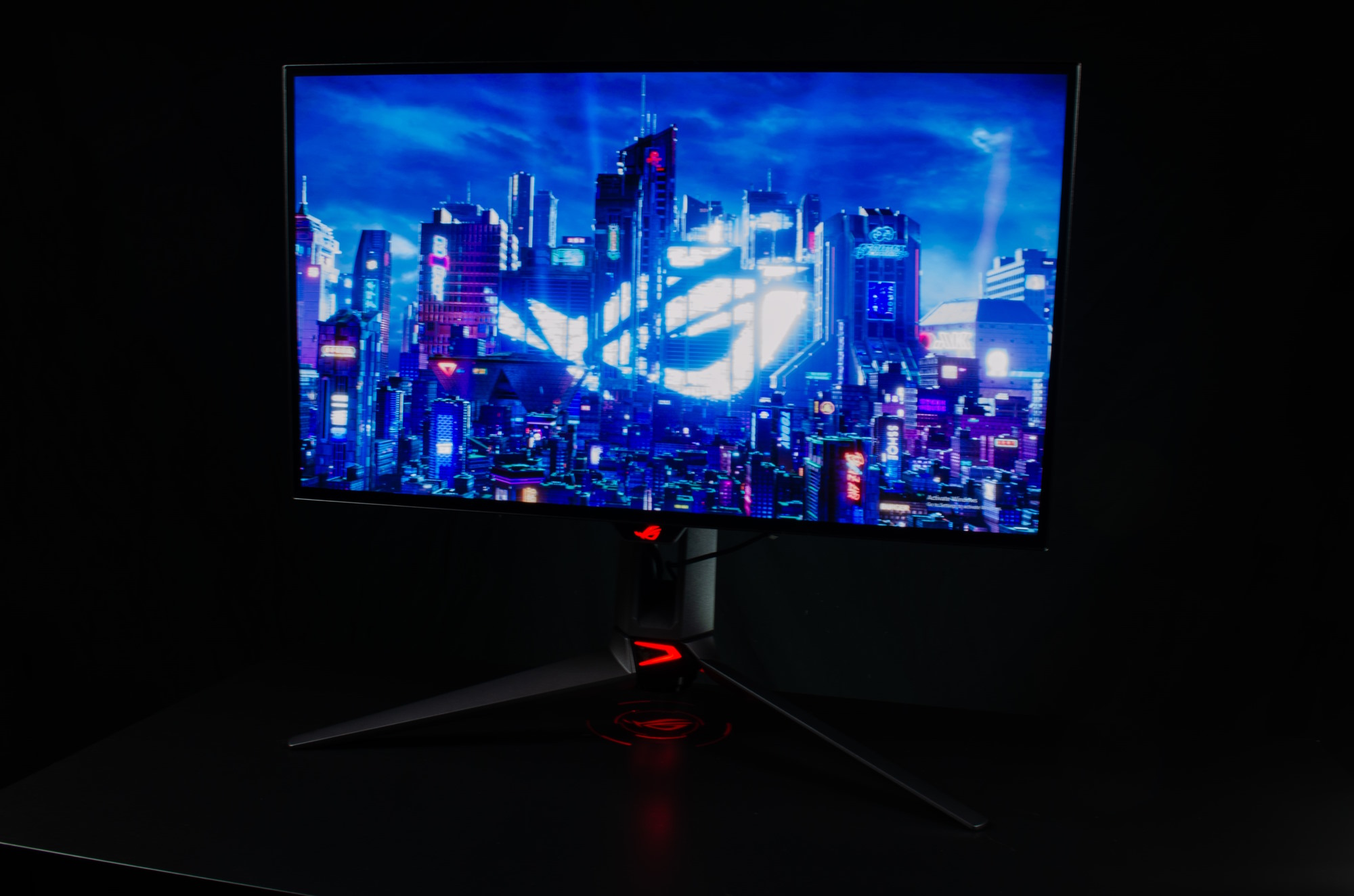 Full gaming setup including the ROG Swift OLED PG27AQDM sitting on a desk
