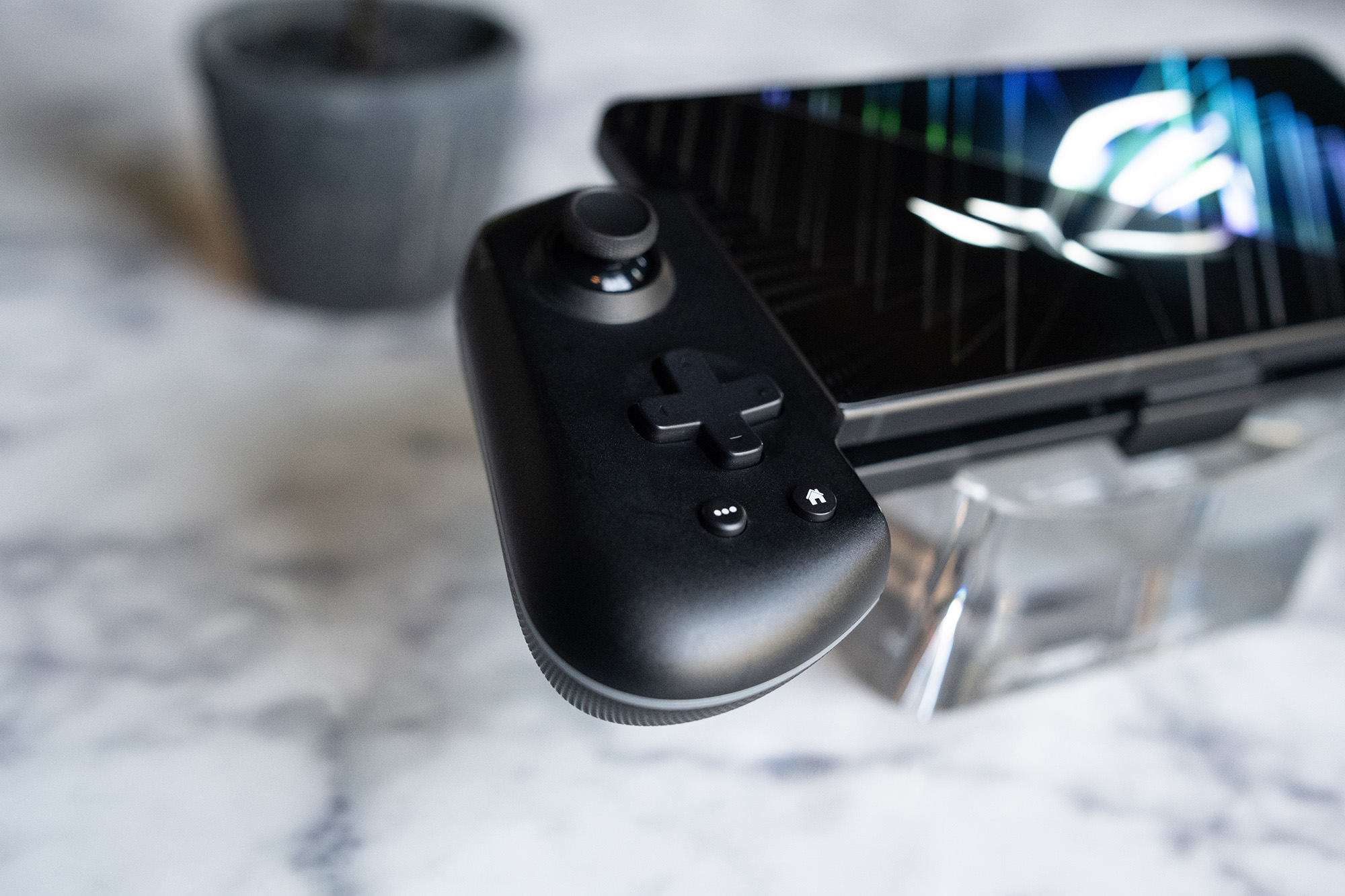 The ROG Tessen mobile controller elevated on a transparent base