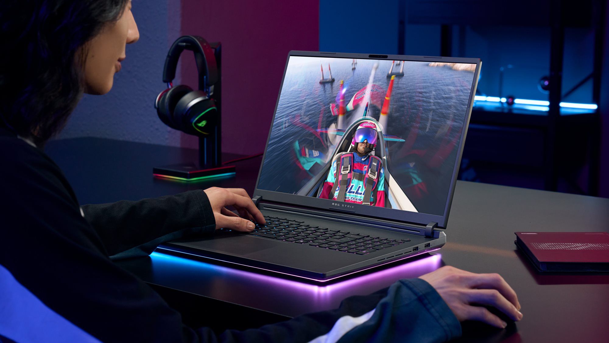 A man playing a game on an ROG Strix laptop.