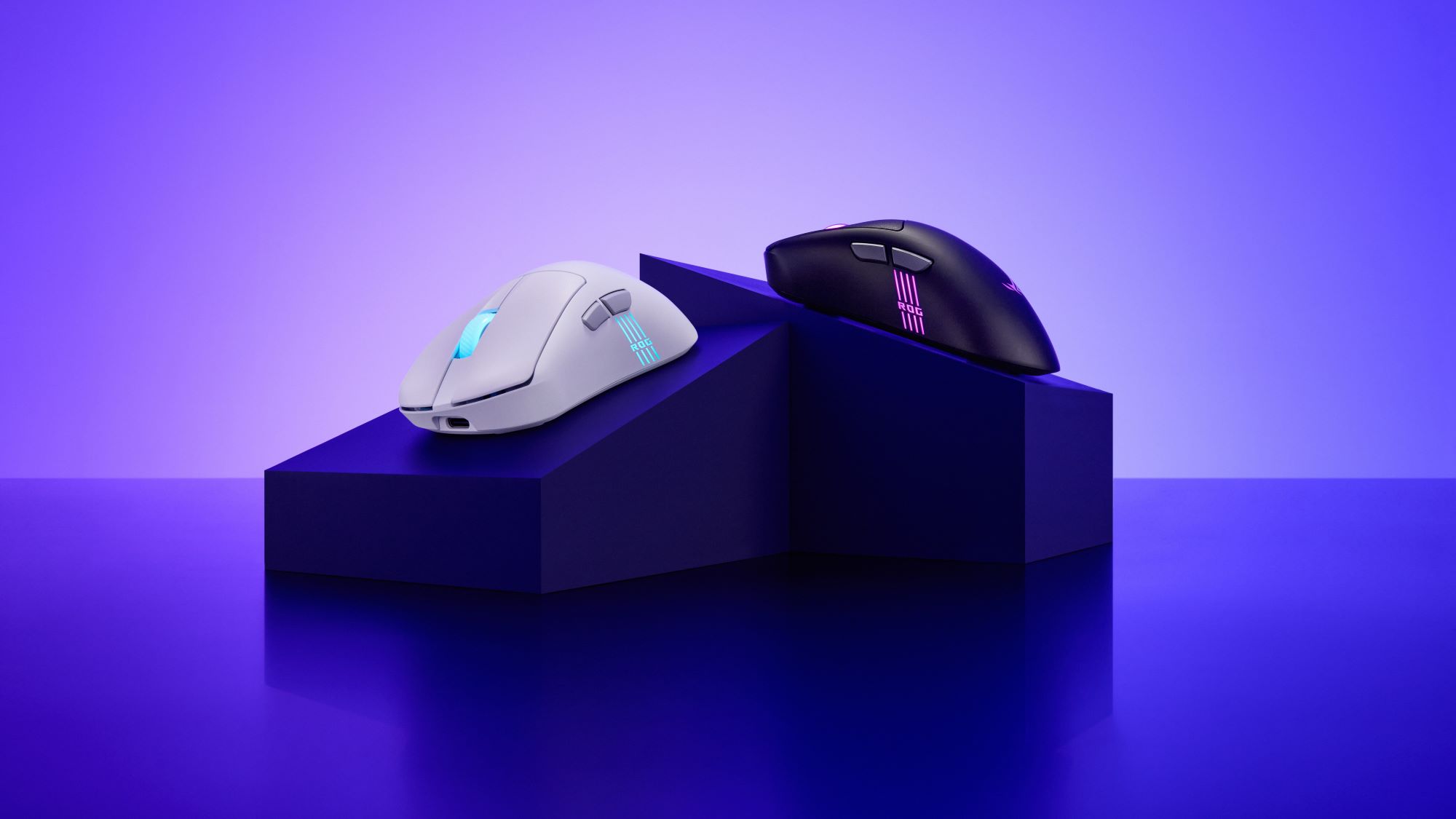 ROG Keris II Origin mice on a black platform against a purple backdrop.