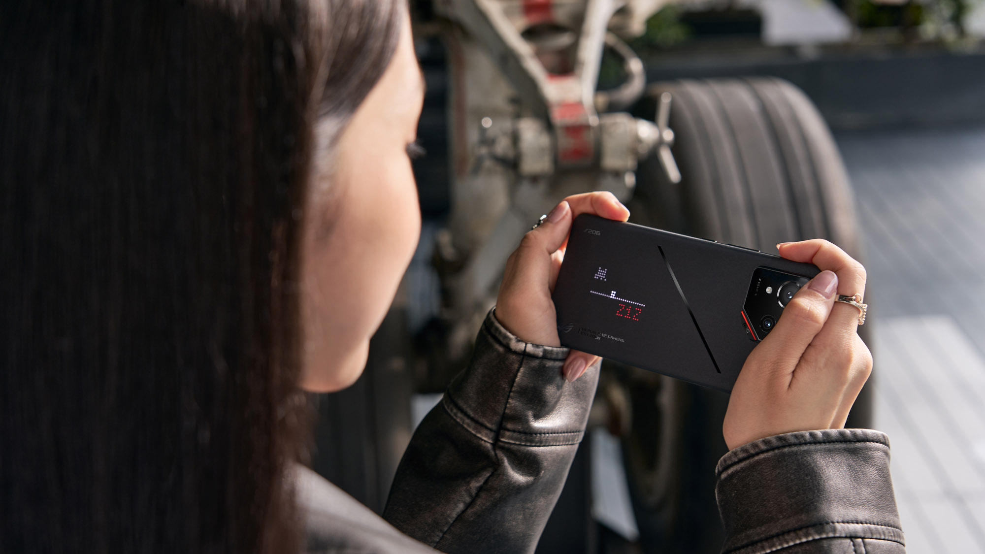 A woman playing games on the AniMe Play display of the ROG Phone 9