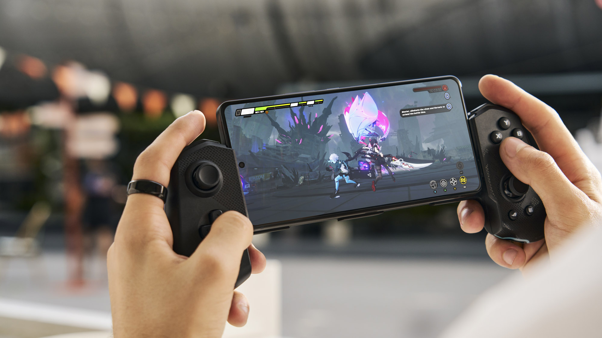 Two hands holding an ROG Phone 9 with the ROG Tessen mobile controller